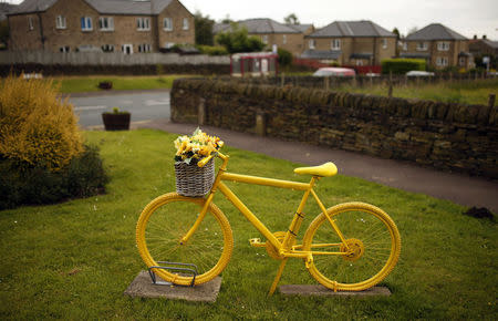 A yellow bicycle is pictured on the route of the Tour de France in the village of Barkisland, northern England June 17, 2014. REUTERS/Phil Noble