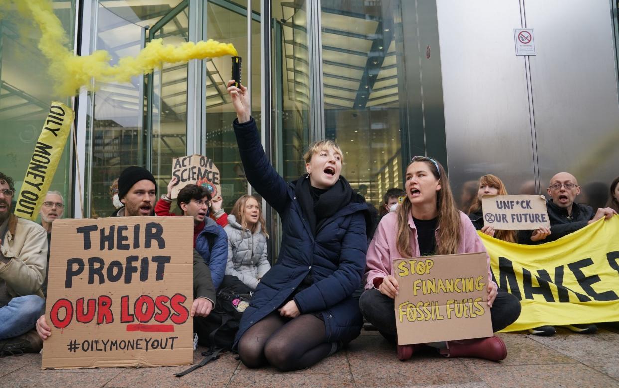 Climate activist Greta Thunberg (centre back) joins protesters from Fossil Free London in a demonstration outside J.P.Morgan's Canary Wharf offices