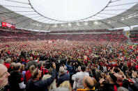 Leverkusen fans run on the pitch after Bayer Leverkusen won the German Bundesliga title beating Werder Bremen in Leverkusen, Germany, Sunday, April 14, 2024. (AP Photo/Martin Meissner)