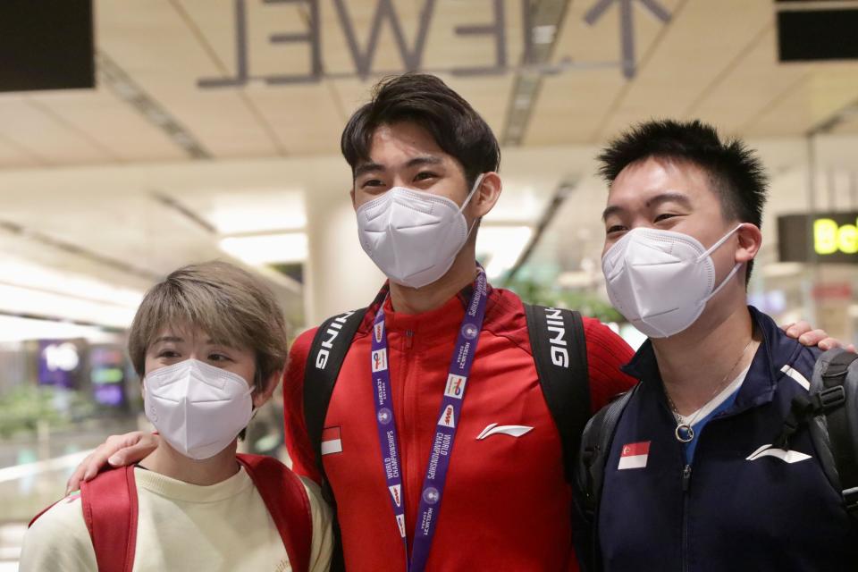 Badminton world champion Loh Kean Yew with his physio Ho Jiaying (left) and coach Kelvin Ho after landing at Changi Airport. (PHOTO: Dhany Osman/Yahoo News Singapore)