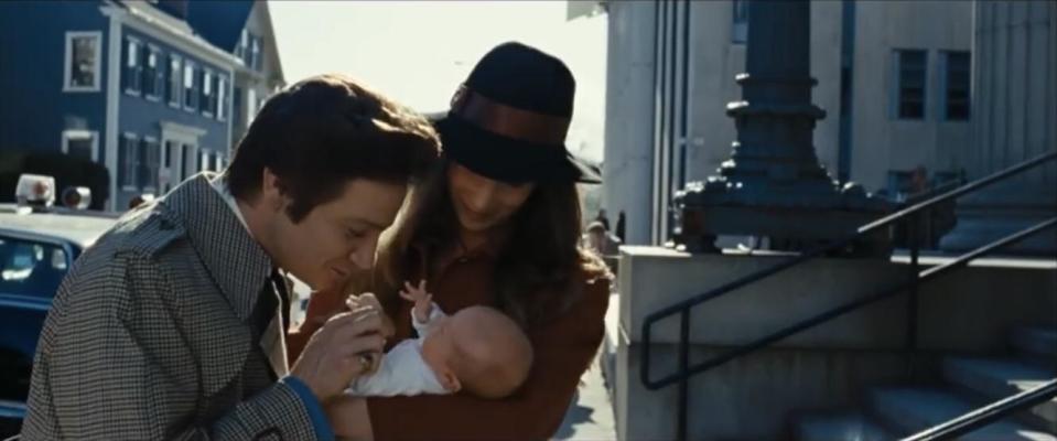 Jeremy Renner as Mayor Carmine Polito kissing a baby in American Hustle