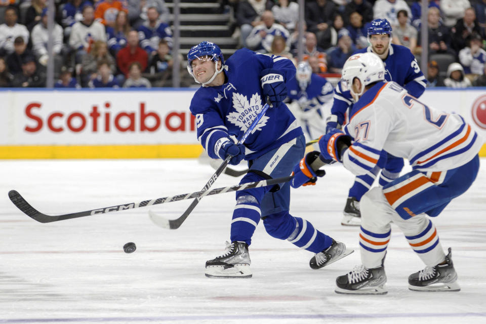 Toronto Maple Leafs center Calle Jarnkrok (19) shoots as Edmonton Oilers defenseman Brett Kulak (27) during the second period of an NHL hockey game in Toronto, Saturday, March 11, 2023. (Cole Burston/The Canadian Press via AP)
