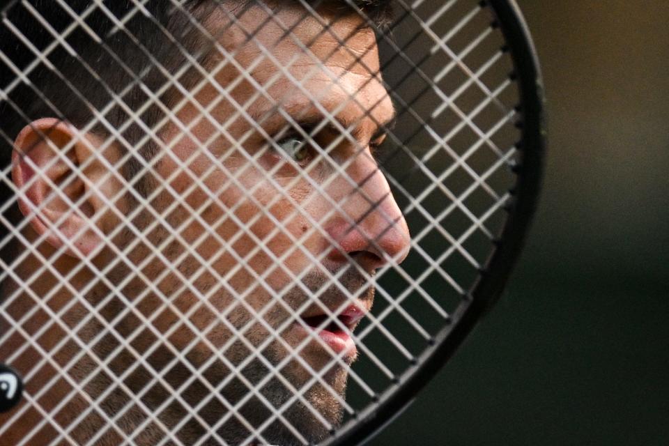 Serbia's Novak Djokovic reacts as he plays against Australia's Alexei Popyrin during their men's singles tennis match on the sixth day of the 2024 Wimbledon Championships at The All England Lawn Tennis and Croquet Club in Wimbledon, southwest London, on July 6, 2024. (Photo by ANDREJ ISAKOVIC / AFP) / RESTRICTED TO EDITORIAL USE (Photo by ANDREJ ISAKOVIC/AFP via Getty Images) ORG XMIT: 776132251 ORIG FILE ID: 2160277745