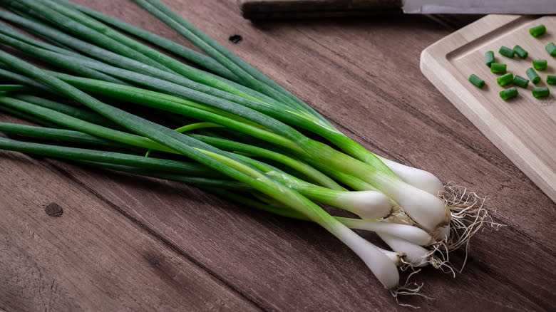 Green onions on wooden table