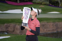 Nelly Korda kisses the trophy as she poses for photographers after winning the LPGA T-Mobile Match Play golf tournament Sunday, April 7, 2024, in North Las Vegas, Nev. (AP Photo/John Locher)
