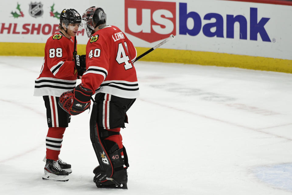 Chicago Blackhawks' Patrick Kane (88) celebrates with goalie Robin Lehner (40) after defeating the Minnesota Wild 5-3 in an NHL hockey game Sunday, Dec. 15, 2019, in Chicago. (AP Photo/Paul Beaty)