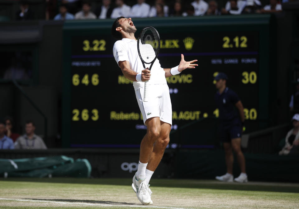 Serbia's Novak Djokovic reacts as he plays against Spain's Roberto Bautista Agut in a Men's singles semifinal match on day eleven of the Wimbledon Tennis Championships in London, Friday, July 12, 2019. (Carl Recine/Pool Photo via AP)