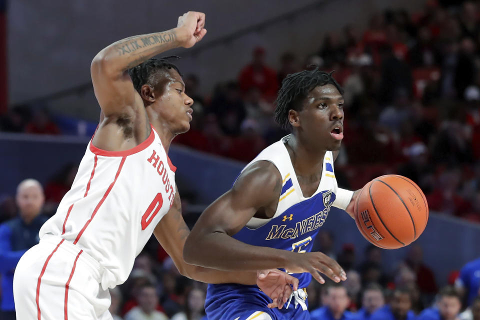 McNeese State guard Johnathan Massie, right, works around Houston guard Marcus Sasser (0) during the first half of an NCAA college basketball game Wednesday, Dec. 21, 2022, in Houston. (AP Photo/Michael Wyke)