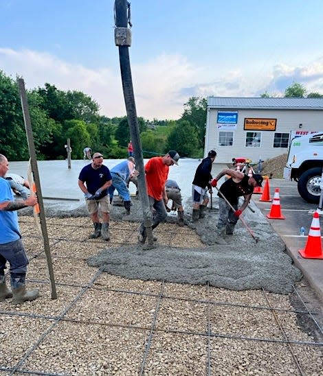 More than a dozen workers volunteered their skills to lay the foundation for the house project at West Holmes High School.