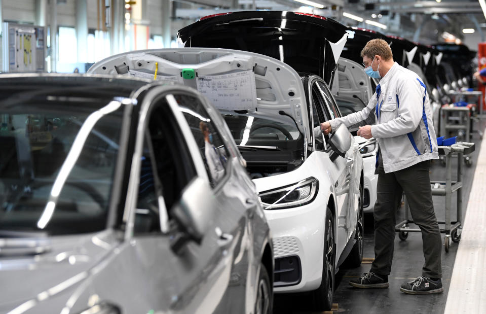 A worker wears a protective mask at the final assembly line for the electric Volkswagen model ID.3 in Zwickau, Germany, April 23, 2020, as the spread of the coronavirus disease (COVID-19) continues.    Hendrik Schmidt/Pool via REUTERS