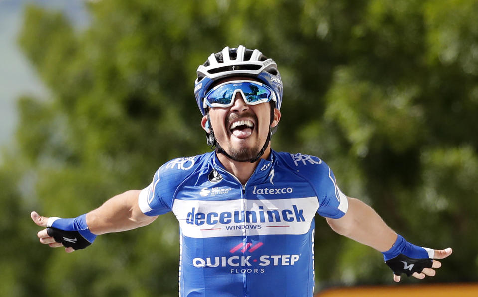 France's Julian Alaphilippe celebrates as he crosses the finish line to win the third stage of the Tour de France cycling race over 215 kilometers (133,6 miles) with start in Binche and finish in Epernay, Monday, July 8, 2019. (AP Photo/Christophe Ena)