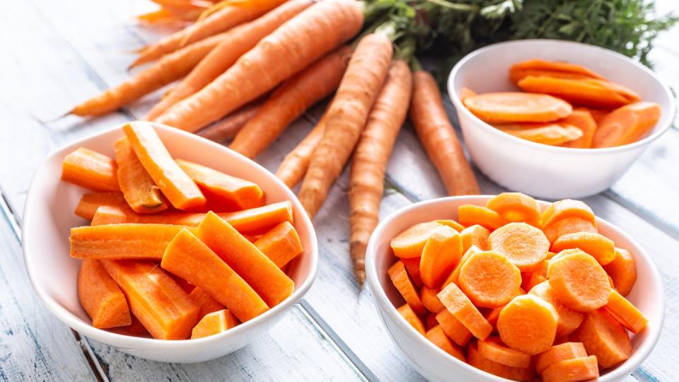 fresh carrot and carrots slices on table