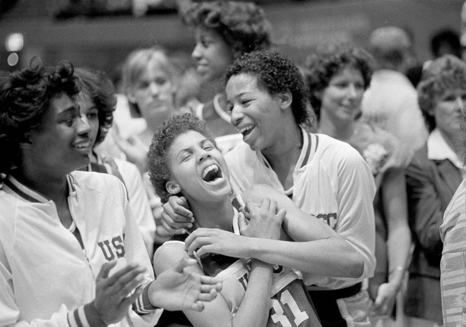 FILE - University of Southern California's Cheryl Miller, center left, and Cynthia Cooper, center right, rejoice after winning the NCAA women's basketball championship by defeating the University of Tennessee 72-61 in Los Angeles, April 1, 1984. Miller was named MVP of the tournament. Iowa's Caitlin Clark will soon be the NCAA's scoring leader. That's fact and, in many minds, enough to put the 22-year-old star high up among the greats of college basketball. (AP Photo/Lennox McLendon, FIle)