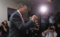 Speaker of the House John Boehner pumps his fist as he emerges from a meeting with Republican House members in the U.S. Capitol in Washington October 16, 2013. REUTERS/Kevin Lamarque