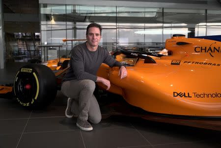 Nascar driver Jimmie Johnson poses for a photograph with an F1 car at the McLaren Technology Centre in Woking, Britain November 21, 2018. REUTERS/Will Russell