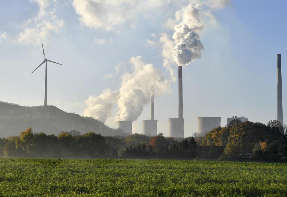 FILE - In this Nov. 27, 2017 file photo a coal-burning power plant steams in Gelsenkirchen, Germany. While other German mainstream parties flounder in polls and struggle to find an answer to a far-right challenge, the Greens have gone from strength to strength over the last year. They stand for climate protection and a largely liberal approach to migration. (AP Photo/Martin Meissner, file)