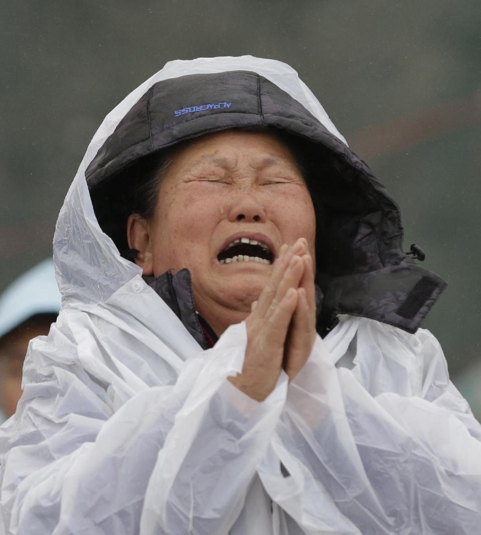 A relative of a missing passenger aboard the sunken ferry Sewol in the water off the southern coast prays while crying at a port in Jindo, south of Seoul, South Korea, Friday, April 18, 2014. Rescuers scrambled to find hundreds of ferry passengers still missing Friday and feared dead, as fresh questions emerged about whether quicker action by the captain of the doomed ship could have saved lives. (AP Photo/Lee Jin-man)