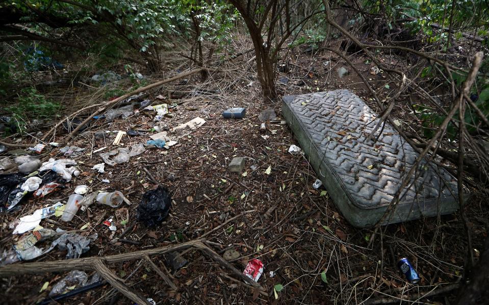 An area frequented by drug users on the edge of the Knollwood community of Claymont is strewn with trash, Wednesday, Aug. 4, 2021.