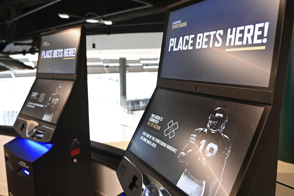 FILE - Betting kiosks are seen inside Caesars Sportsbook inside Rocket Mortgage FieldHouse, Thursday, Dec. 29, 2022, in Cleveland. The stakes are higher in Ohio this year for March Madness — and not just because it's a regional host for the first round of the men's NCAA basketball tournament. For the first time, sports fans in Ohio are able to click on a mobile app — or tap into kiosk at a bar, restaurant or grocery store — and legally bet on the famed basketball tournament. (AP Photo/David Dermer, File)