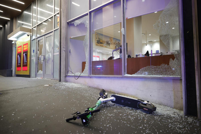 Broken windows at a Wells Fargo branch are seen following a violent protest, late Saturday, Jan. 21, 2023, in Atlanta, in the wake of the death of an environmental activist killed after authorities said the 26-year-old shot a state trooper. (AP Photo/Alex Slitz)
