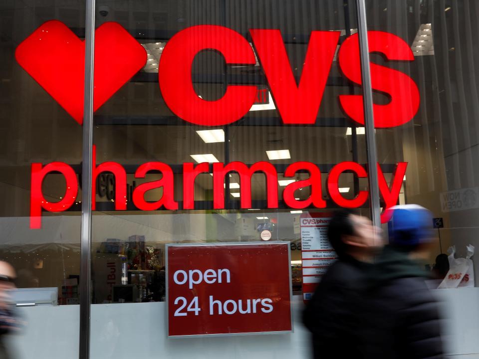 FILE PHOTO: People walk by a CVS Pharmacy store in the Manhattan borough of New York City, New York, U.S., November 30, 2017. REUTERS/Shannon Stapleton