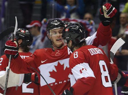 Canada's Drew Doughty (8) celebrates his game-winning overtime goal against Finland with teammate Jonathan Toews during their men's preliminary round ice hockey game at the 2014 Sochi Winter Olympics, February 16, 2014. REUTERS/Jim Young