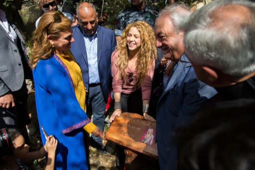 A handout picture from the Honorary Consulate of Lebanon in Barranquilla, Colombia, on July 13, 2018 shows Colombian singer Shakira (C) holding a commemorative plaque bearing her name during her visit to the northern Lebanese village of Tannourine