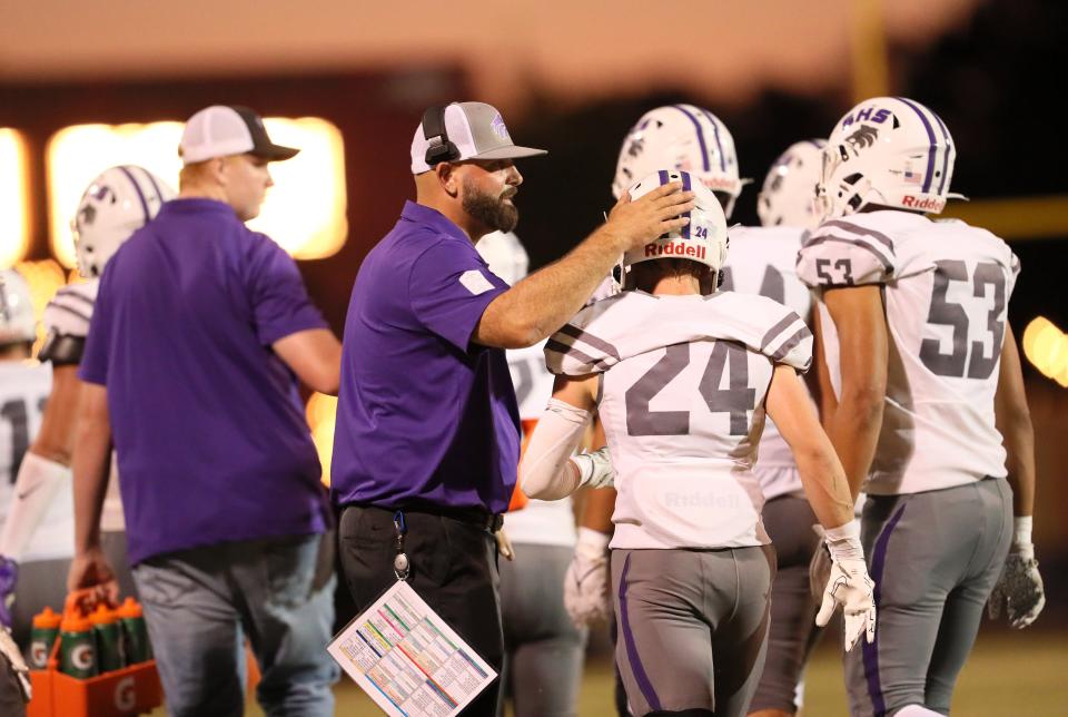 Shasta head coach Aaron Richards (left) congratulates Owen Boesiger (center) on the sideline after Boesiger scored a touchdown early in the 1st quarter at the Pasture on Friday, Sept. 8, 2023.