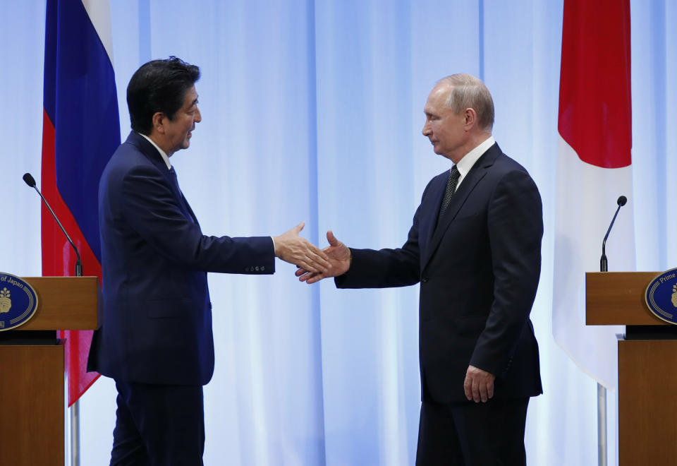 Russian President Vladimir Putin, right, shakes hands with Japanese Prime Minister Shinzo Abe at their news conference at G-20 leaders summit in Osaka, Japan, Saturday, June 29, 2019. (Kim Kyung-Hoon/Pool Photo via AP)