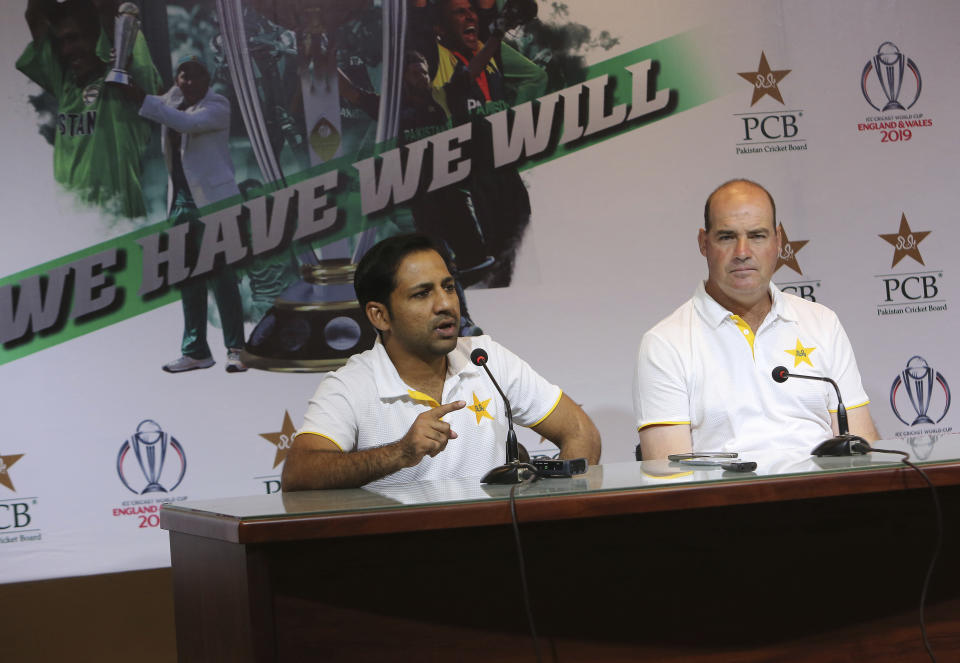 Pakistan's cricket team captain Sarfaraz Ahmed, left, addresses a news conference with coach Mickey Arthur, in Lahore, Pakistan, Monday, April 22, 2019. Ahmed likes that Pakistan is considered an underdog entering the World Cup beginning next month in England but insisted that despite the label, the 15-member squad is well prepared. (AP Photo/K.M. Chaudary)