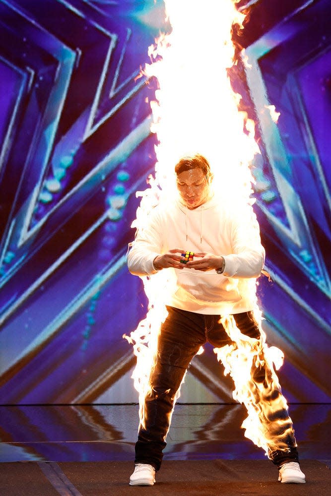 Rubik's cube solver Thomas Vu upped the ante on his speedy cube-solving skills by greasing himself up and lighting himself on fire during his act.