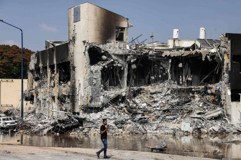 A man walks past an Israeli police station in Sderot after it was damaged during battles to dislodge Hamas militants who were stationed inside, on October 8, 2023. / Credit: Ronaldo Schemidt/AFP via Getty Images