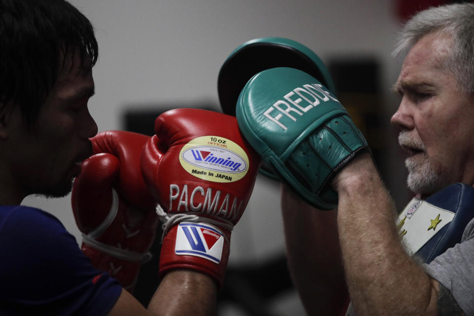 Boxer Manny Pacquiao, left, trains with Freddie Roach at the Wild Card Boxing Club Monday, Jan. 14, 2019, in Los Angeles. The Filipino legend is in the winter of his career, gearing up for what could be one big last fight. Saturday's bout versus Broner isn't it, but Pacquiao trains with the knowledge that a second megafight against Floyd Mayweather could possibly be just months away if all goes well. (AP Photo/Jae C. Hong)