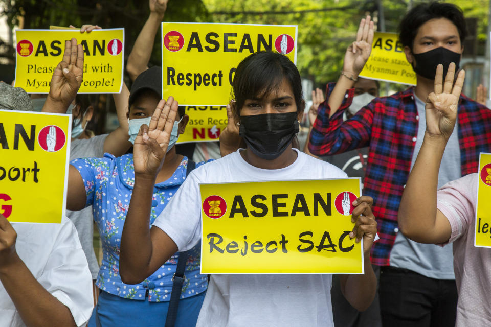 Anti-coup protesters flash the three-finger sign of defiance during the demonstration against the military coup in Yangon, Myanmar, on Friday, April 23, 2021. Leaders of the 10-member Association of Southeast Asian Nations meet Saturday, April 24, in Jakarta to consider plans to promote a peaceful resolution of the conflict that has wracked Myanmar since its military launched a deadly crackdown on opponents to its seizure of power in February. (AP Photo)