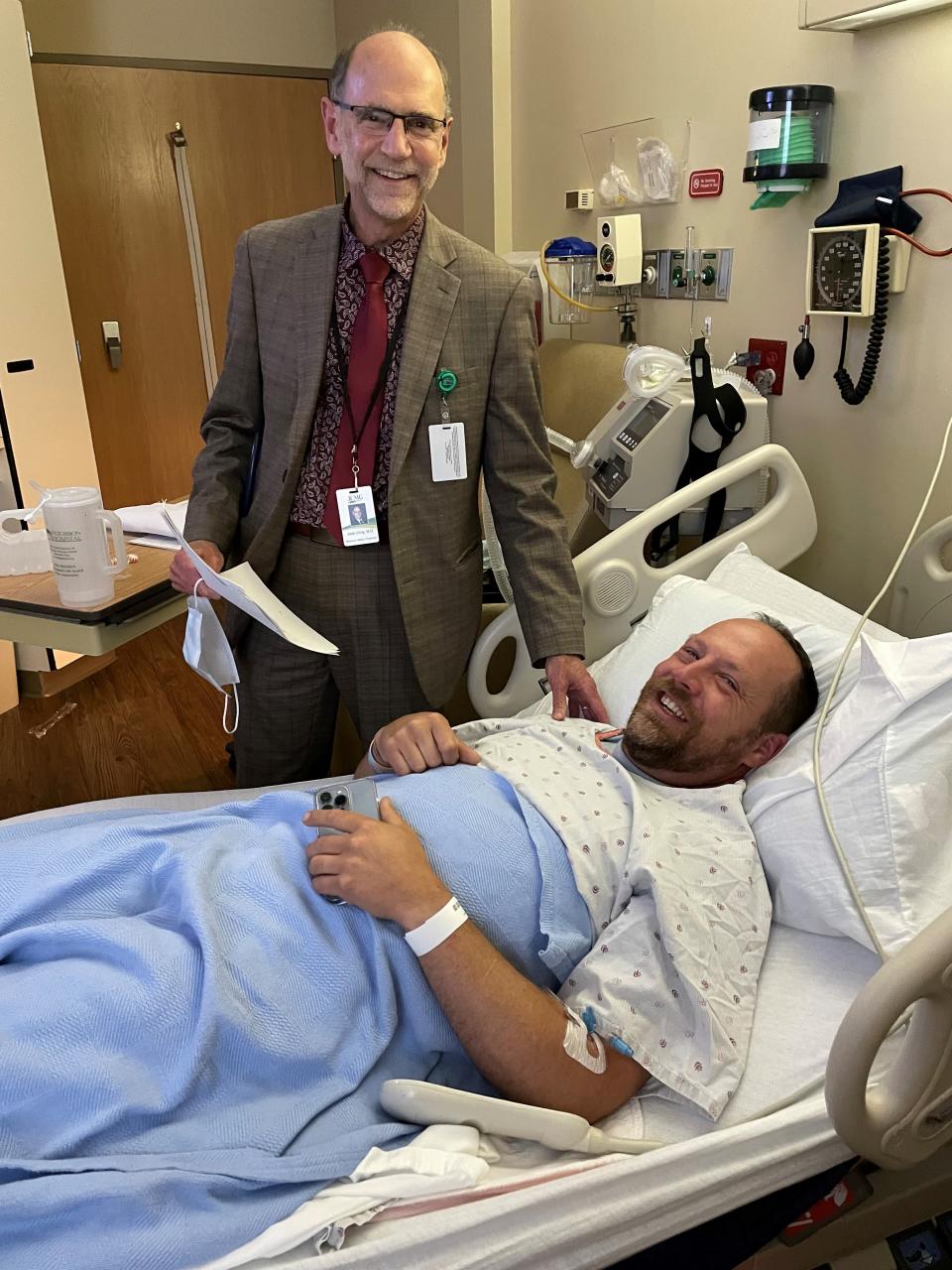 Jonathan Awe of Appleton is recovering at Fitzgibbon Hospital in Marshall, Missouri, after being injured in a train derailment. He's pictured with Dr. Jack Uhrig.