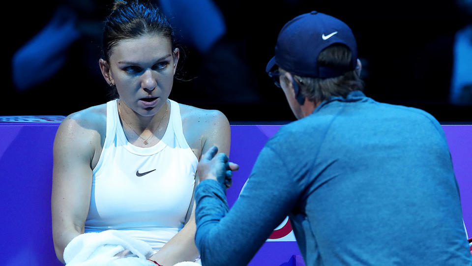 Simona Halep (L) of Romania speaks to her coach Darren Cahill during a break in her Women's Singles match against Karolina Pliskova at the 2019 Shiseido WTA Finals. (Photo by Lintao Zhang/Getty Images)