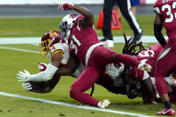 Washington Football Team running back Antonio Gibson (24) scores a touchdown as Arizona Cardinals safety Chris Banjo (31) defends during the second half of an NFL football game, Sunday, Sept. 20, 2020, in Glendale, Ariz. (AP Photo/Ross D. Franklin)