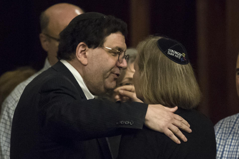 Dor Hadash Rabbi Cheryl Klein, right, and New Light Rabbi Jonathan Perlman embrace after Pennsylvania lawmakers came together in an unusual joint session to commemorate the victims of the Pittsburgh synagogue attack that killed 11 people last year, Wednesday, April 10, 2019, at the state Capitol in Harrisburg, Pa. (AP Photo/Matt Rourke)