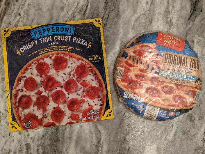 boxes of lidl and aldi&#39;s pepperoni pizza on a counter