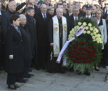 Polish Prime Minister Beata Szydlo, left, and Jaroslaw Kaczynski, second left, the head of the ruling Law and Justice party, attend a ceremony in memory of the late President Lech Kaczynski on the seventh anniversary of a plane crash that that killed Kaczynski, the first lady and 94 others in Russia, in Warsaw, Poland, Monday, April 10, 2017. (AP Photo/Czarek Sokolowski)