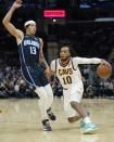 Cleveland Cavaliers' Darius Garland (10) drives against Orlando Magic's R.J. Hampton (13) in the second half of an NBA basketball game, Saturday, Nov. 27, 2021, in Cleveland. The Cavaliers won 105-92. (AP Photo/Tony Dejak)