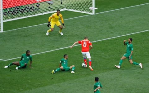 Russia's Denis Cheryshev dribbles past Saudi Arabia players to score his side's second goal during the 2018 soccer World Cup opening match at the Luzhniki stadium in Moscow - Credit: Victor Caivano/AP