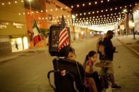 A family is seen on the street that leads to the Paso del Norte International Bridge in Mexico