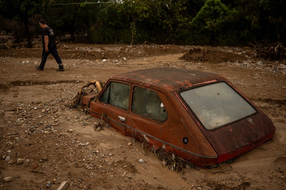 A car partially buried in mud after Storm Elias hit central Greece (AFP via Getty Images)