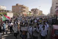 Tens of thousands of Sudanese calling for a civilian government march near the presidential palace in Khartoum, Sudan, Tuesday, Nov. 30, 2021. Security forces have fired tear gas at anti-coup protesters in the Sudanese capital on Tuesday, in the latest demonstrations against a military takeover that took place last month. (AP Photo/Marwan Ali)