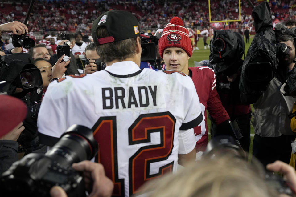 Tampa Bay Buccaneers quarterback Tom Brady (12) greets San Francisco 49ers quarterback Brock Purdy after an NFL football game in Santa Clara, Calif., Sunday, Dec. 11, 2022. (AP Photo/Tony Avelar)