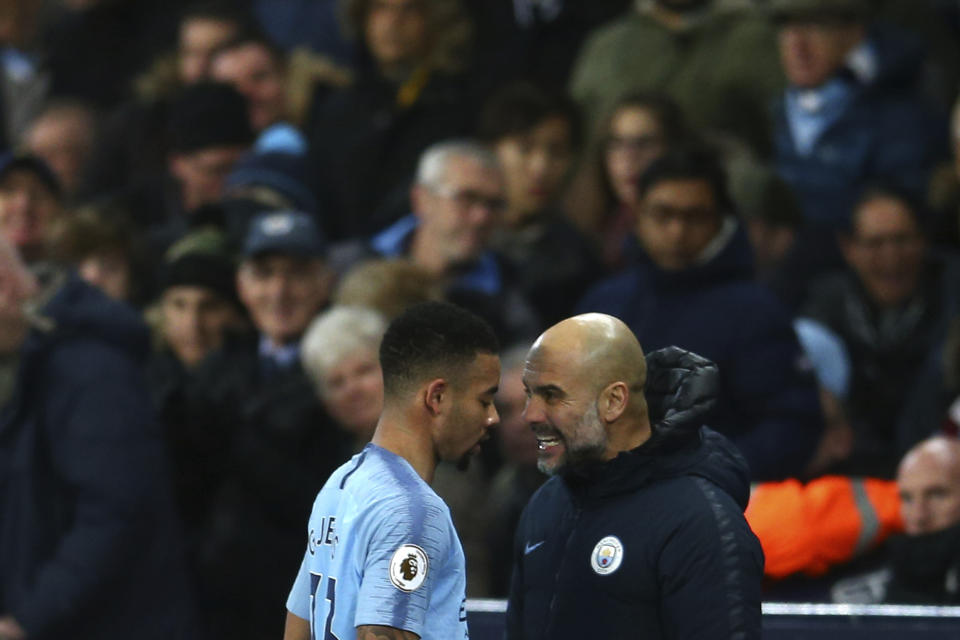 Manchester City's coach Pep Guardiola talks to his player Manchester City's Gabriel Jesus during the English Premier League soccer match between Manchester City and Wolverhampton Wanderers at the Etihad Stadium in Manchester, England, Monday, Jan. 14, 2019. (AP Photo/Dave Thompson)
