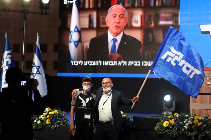 Supporters of Israeli Prime Ministers Benjamin Netanyahu's Likud party react following the announcement of the exit polls in Israel's general elections at the party headquarters in Jerusalem