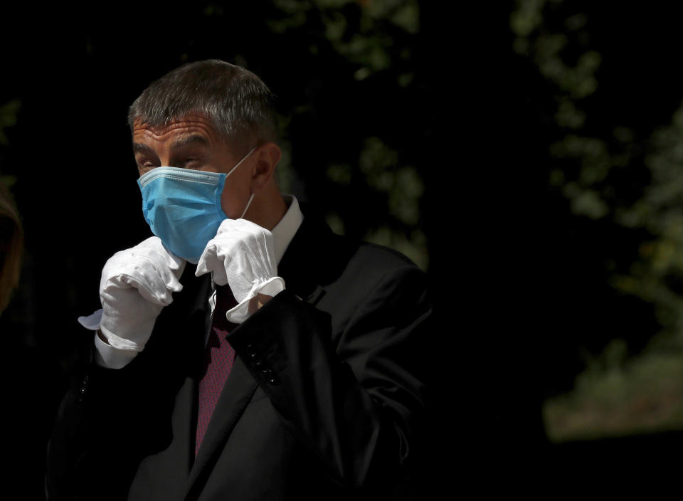 FILE - In this June 3, 2020 file photo Czech Republic's Prime Minister Andrej Babis adjusts his face mask as he waits for the arrival of his Slovak counterpart Igor Matovic in Prague, Czech Republic. (AP Photo/Petr David Josek, File)