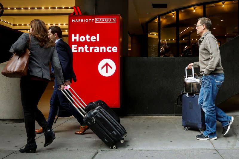 Guests arrive at the Marriott Marquis hotel in Times Square in New York City